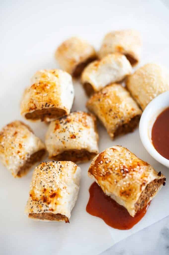 top view of finished sausage rolls with a bowl of tomato sauce