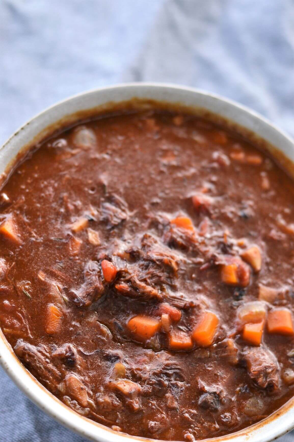 top view of ragu with sauce in grey bowl
