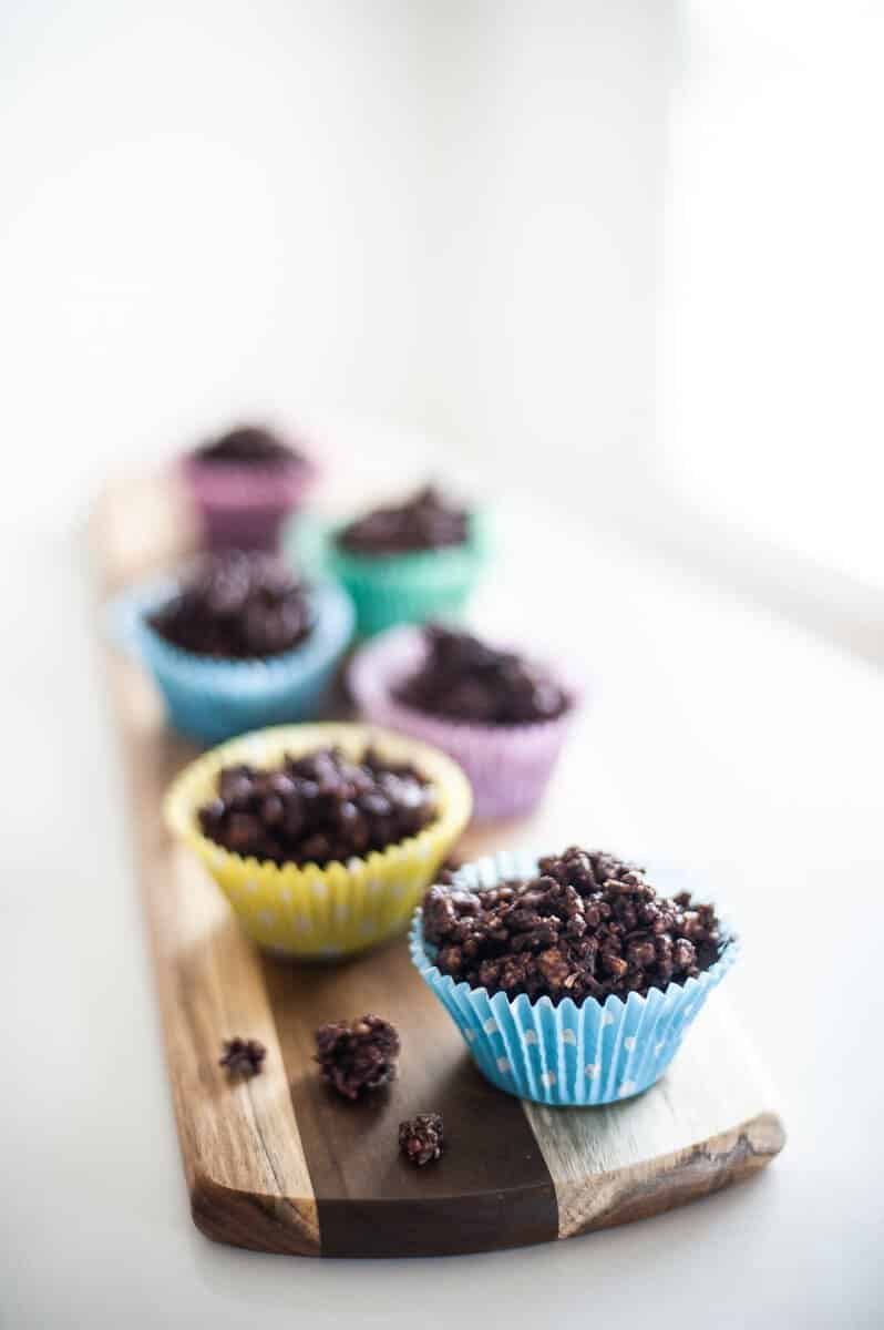 chocolate-crackles-in-coloured-cases-on-wooden-board