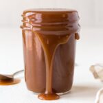 side view of glass jar with caramel sauce dripping from the sides