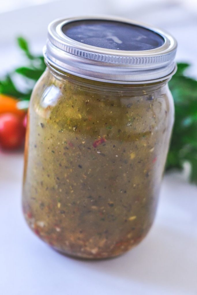 side view of a jar containing salad dressing