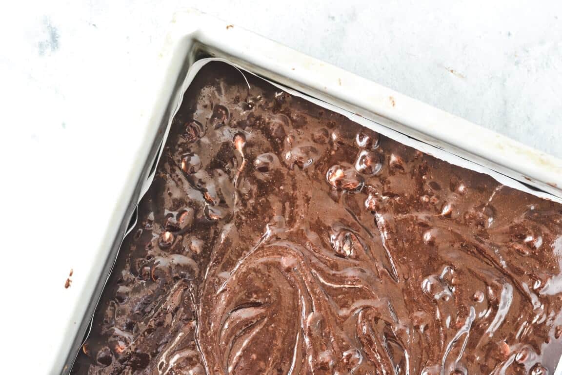 top view of brownie batter in square cake tin