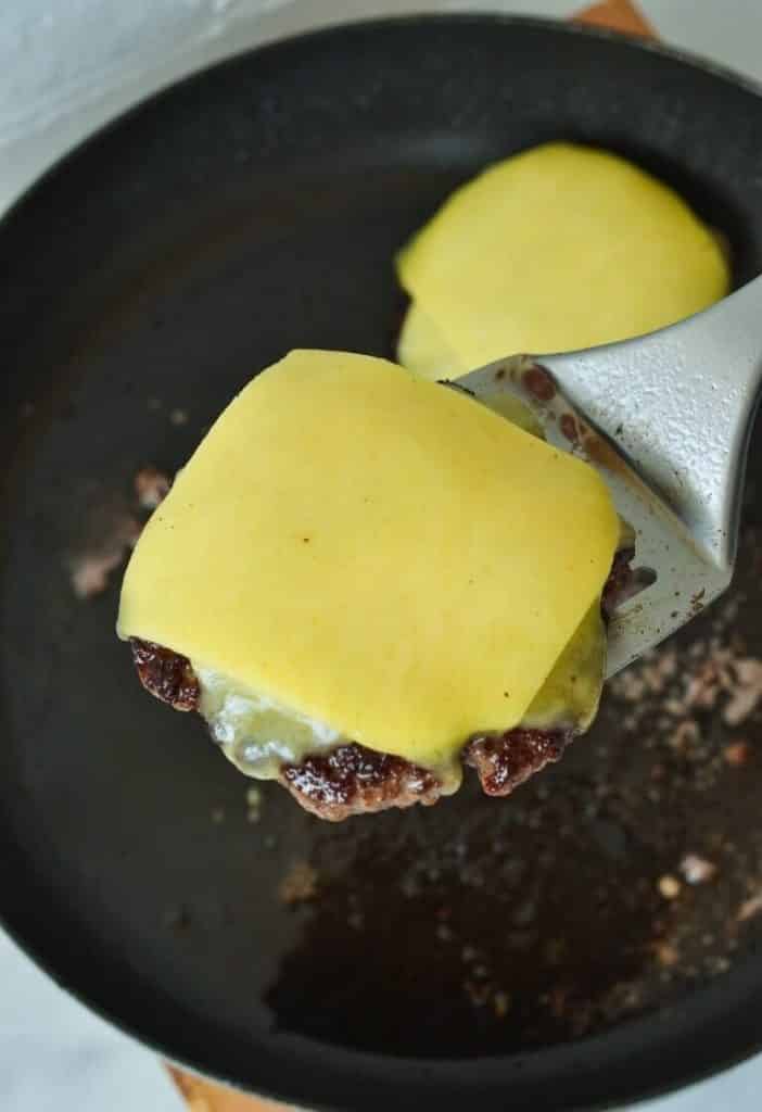 cheese-melting-over-homemade-burger-patty