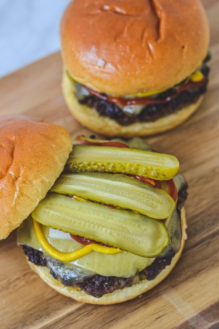 burger-topped-with-pickles-on-board