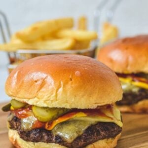 close up of burger on wooden board