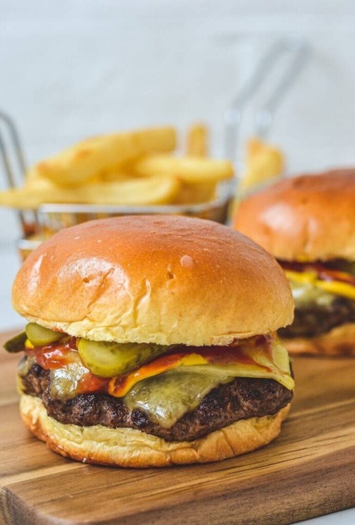 close up of burger on wooden board