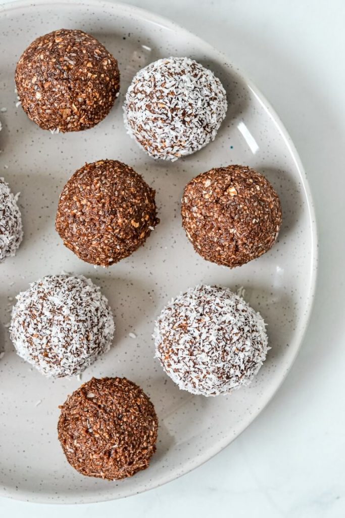 chocolate bliss balls on a white plate