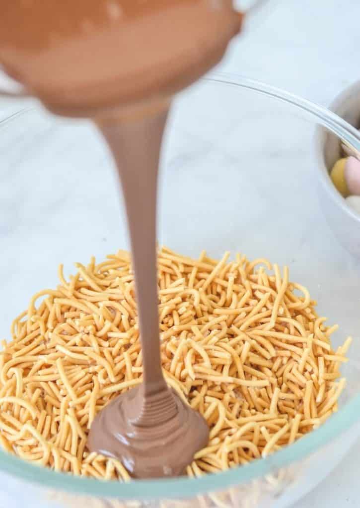 melted chocolate poured over fried noodles in glass bowl