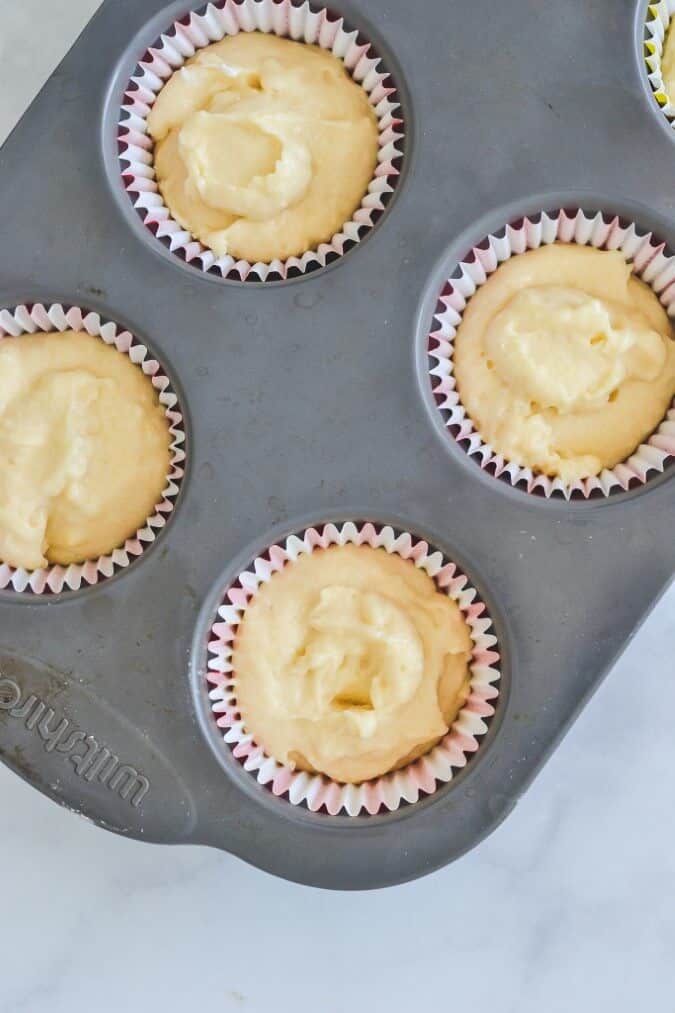 cupcake-batter-in-paper-cases-on-baking-tray
