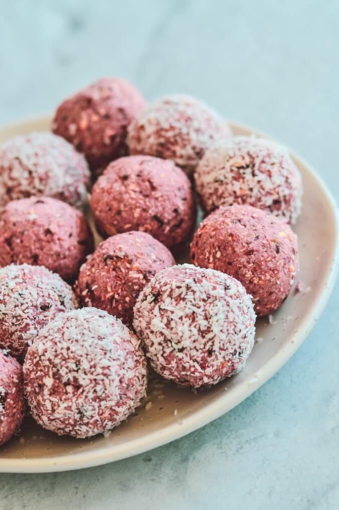 pink-balls-on-white-plate-coated-in-coconut