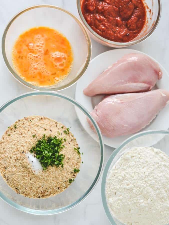 chicken-breast-and-parmigiana-ingredients-on-white-bench