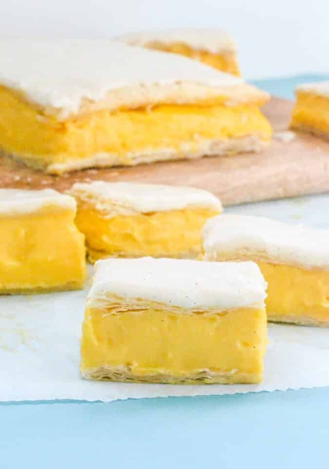 custard-slice-with-white-icing-near-wooden-board