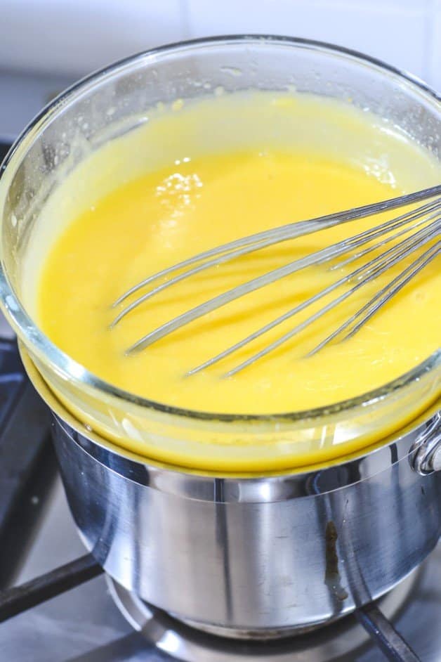thickened-lemon-curd-in-glass-bowl-on-stovetop