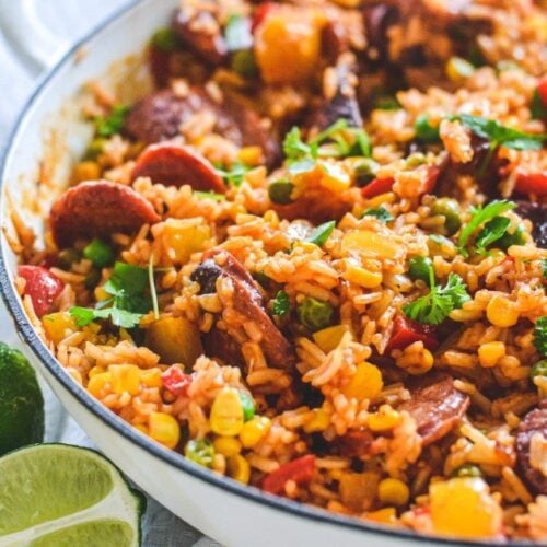 red-rice-in-white-pan-with-chorizo-and-herbs