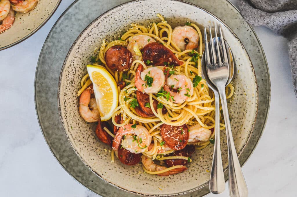 top-view-of-finished-pasta-with-lemon-wedges