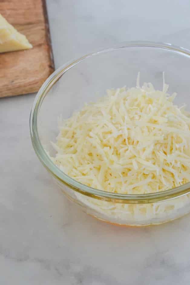 grated pecorino cheese in glass bowl