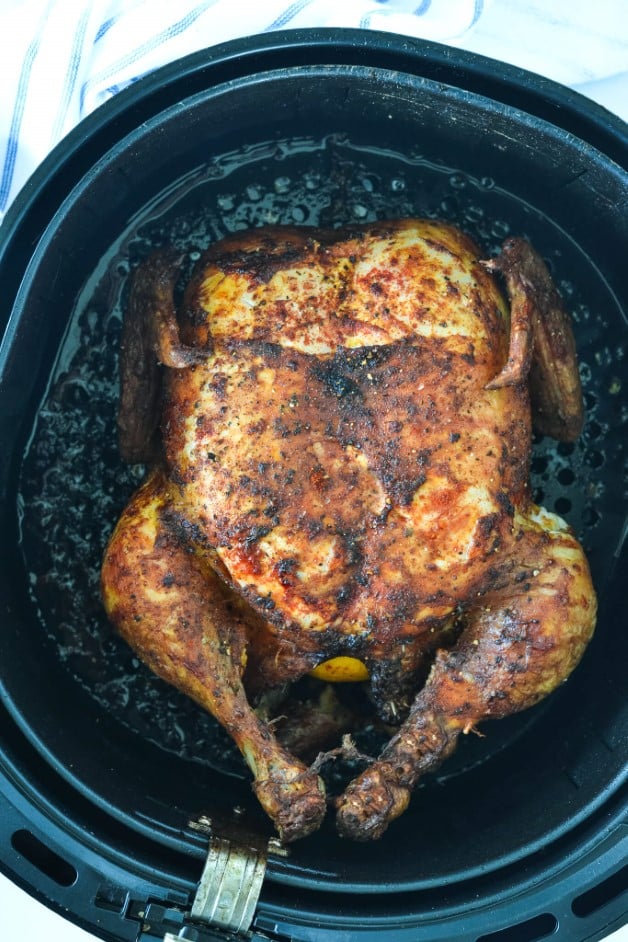 top view of roast chicken in air fryer basket