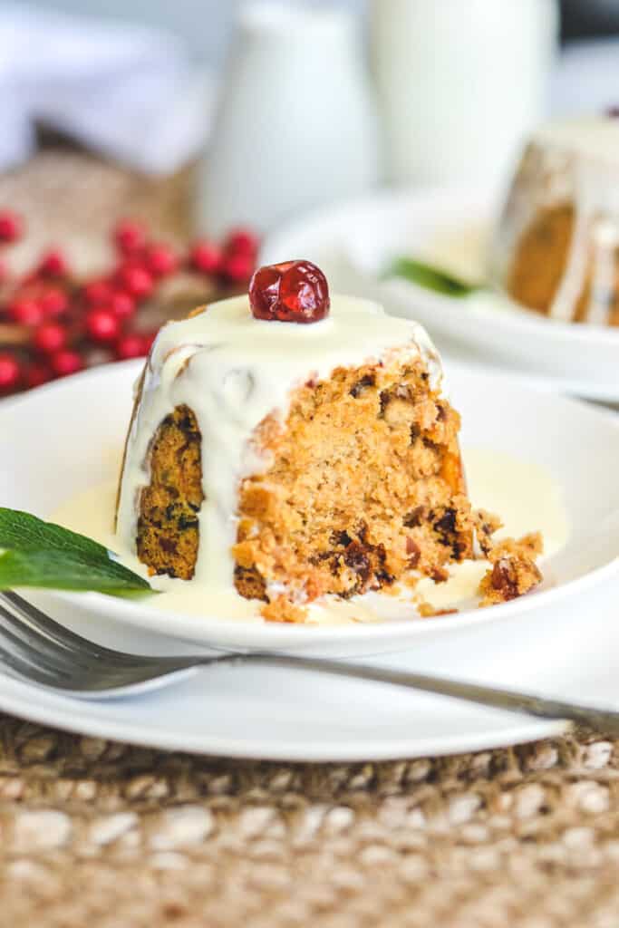 side view of pudding with piece missing, covered with cream