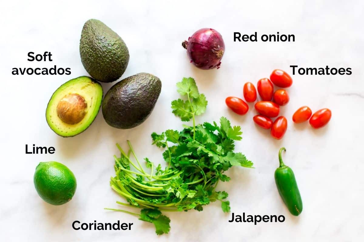 top view of individual ingredients for guacamole laid out on a table