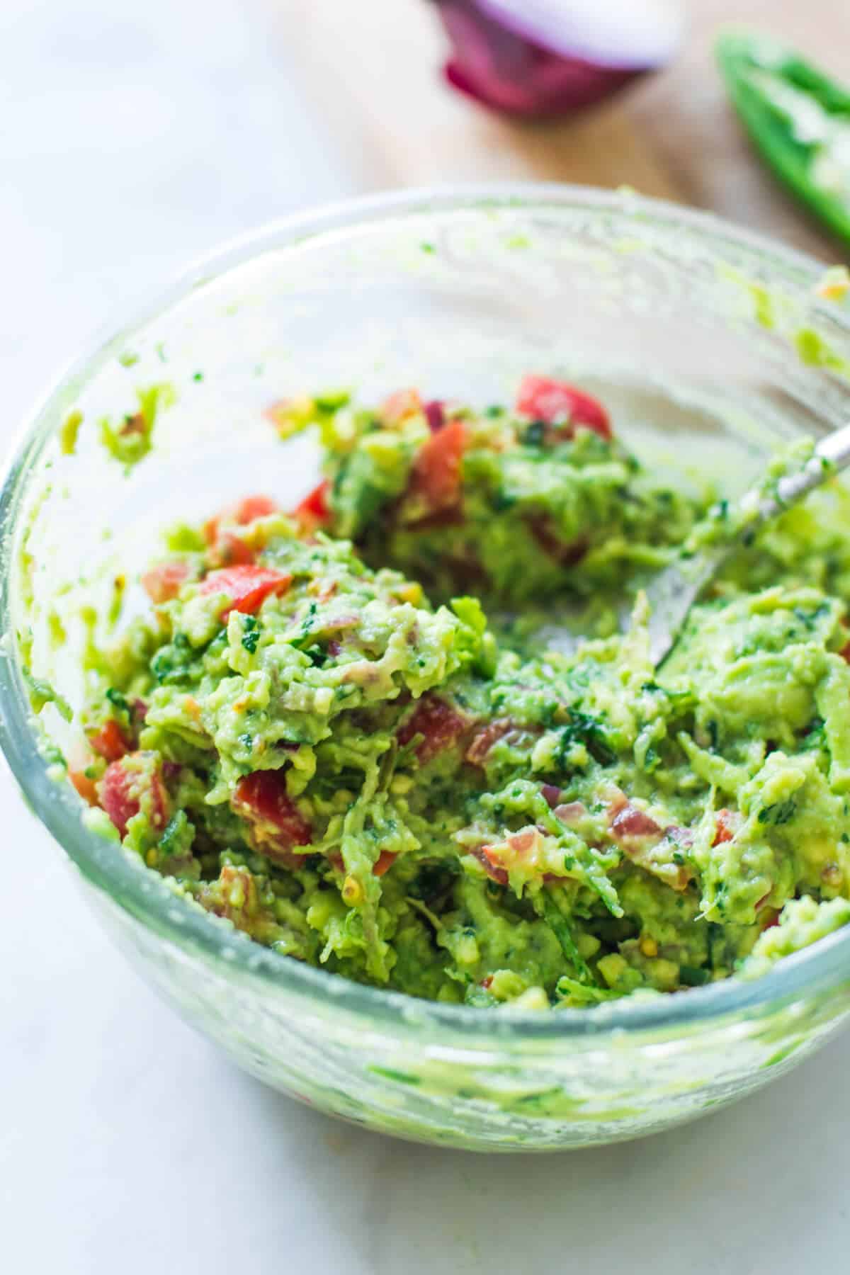 finished guacamole in a glass bowl