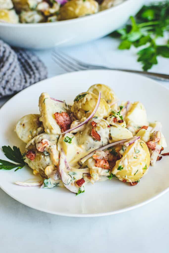 potato salad on a white plate with a fork