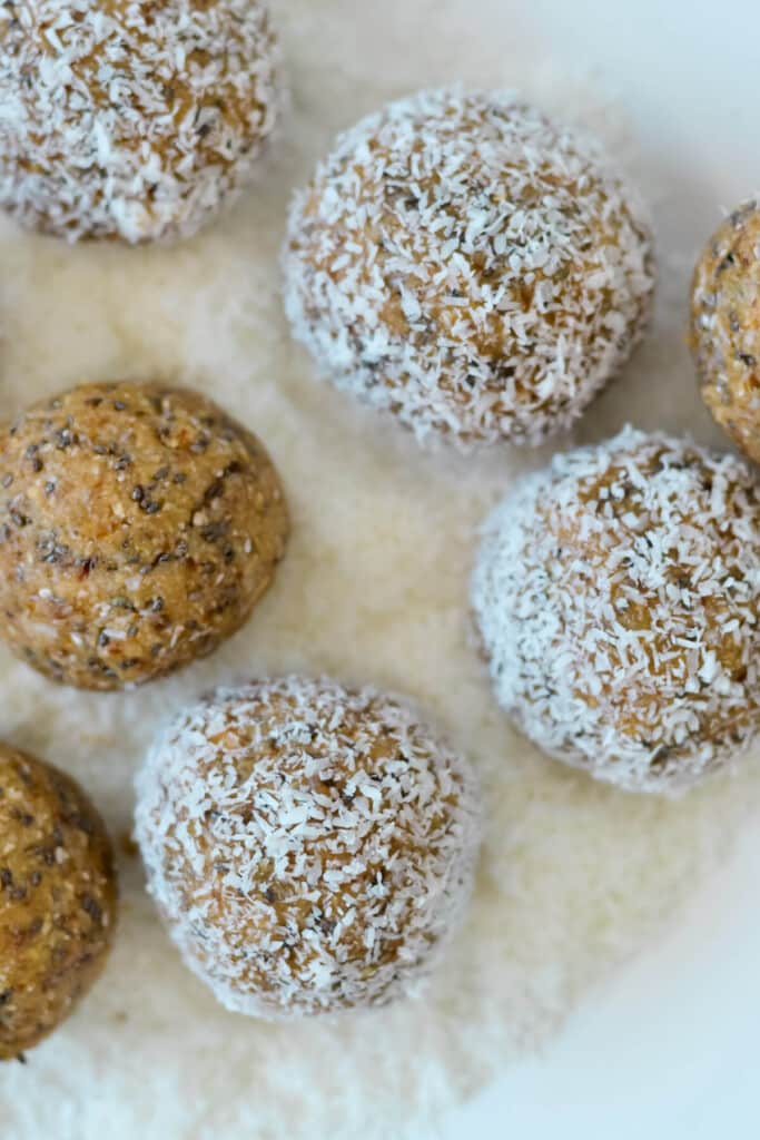 top view of finished bliss balls on a layer of coconut