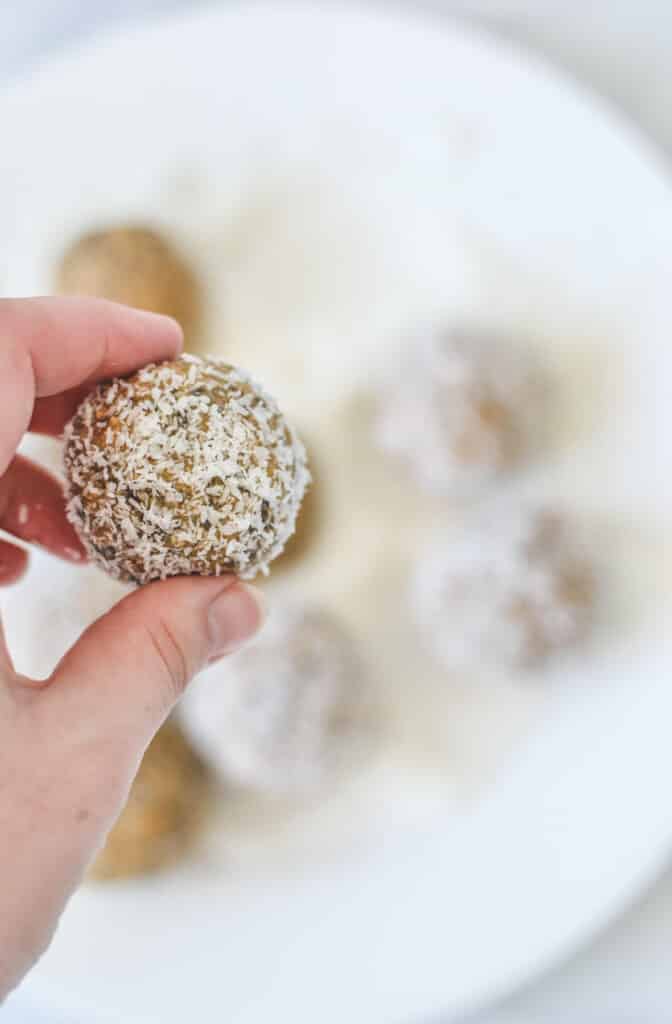 hand holding a finished bliss ball