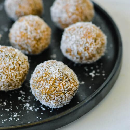 caramel bliss balls on a black plate