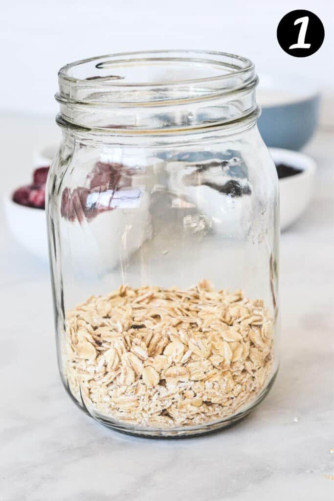 glass mason jar with oats and protein powder in the bottom