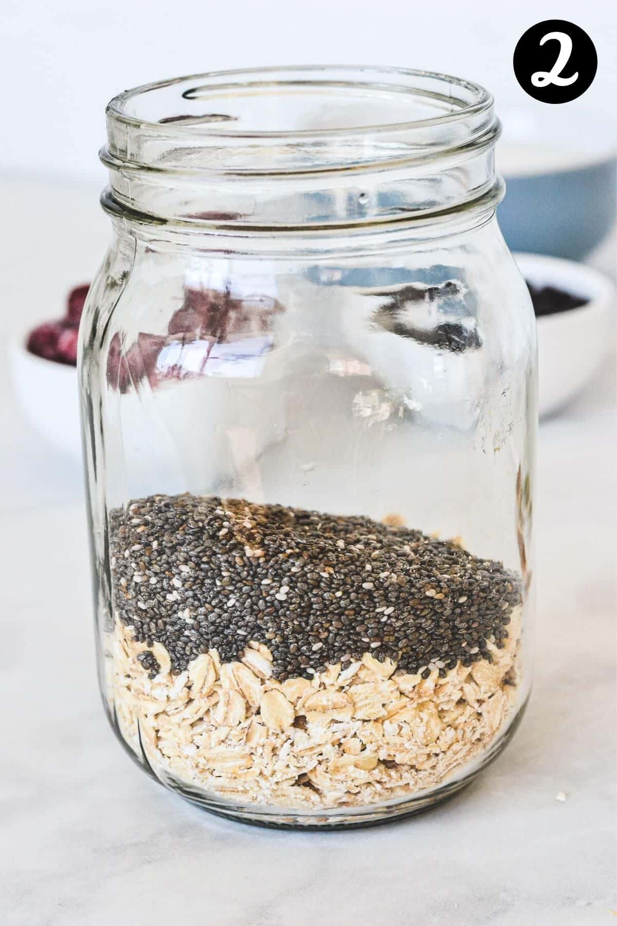 glass mason jar with a layer of chia seeds and oats