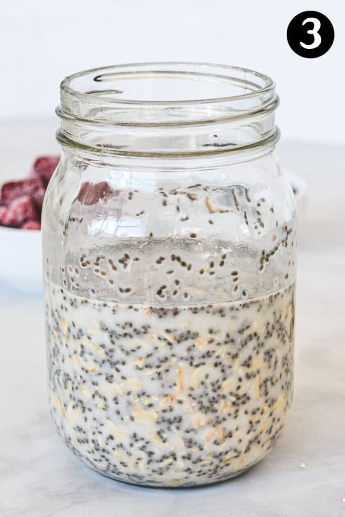milk and oats in a glass mason jar