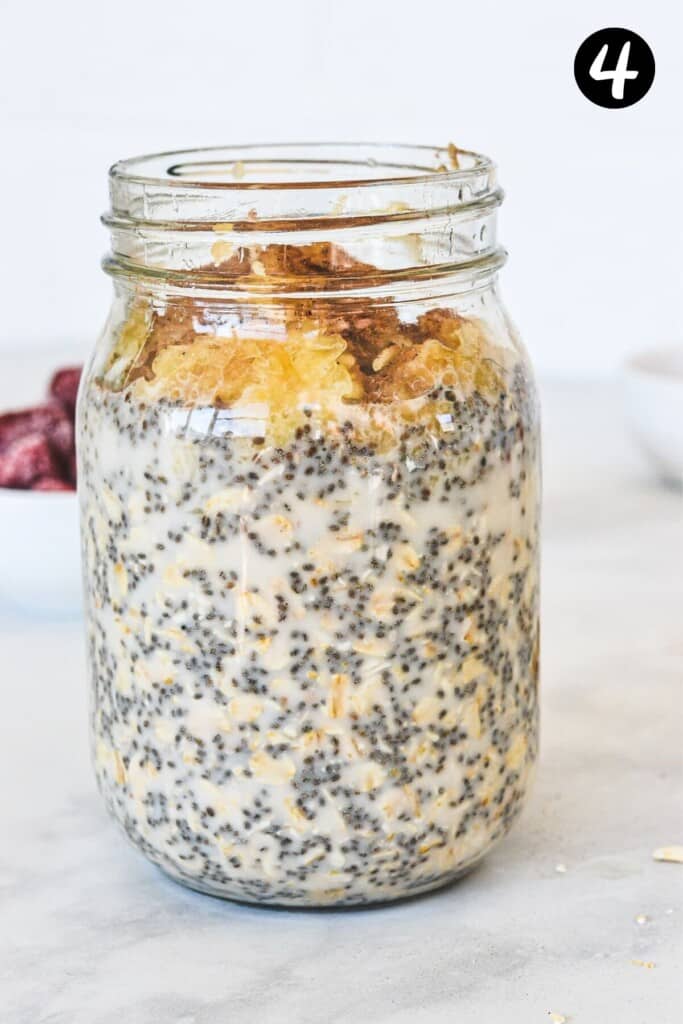 overnight oats and fillings added to a glass mason jar