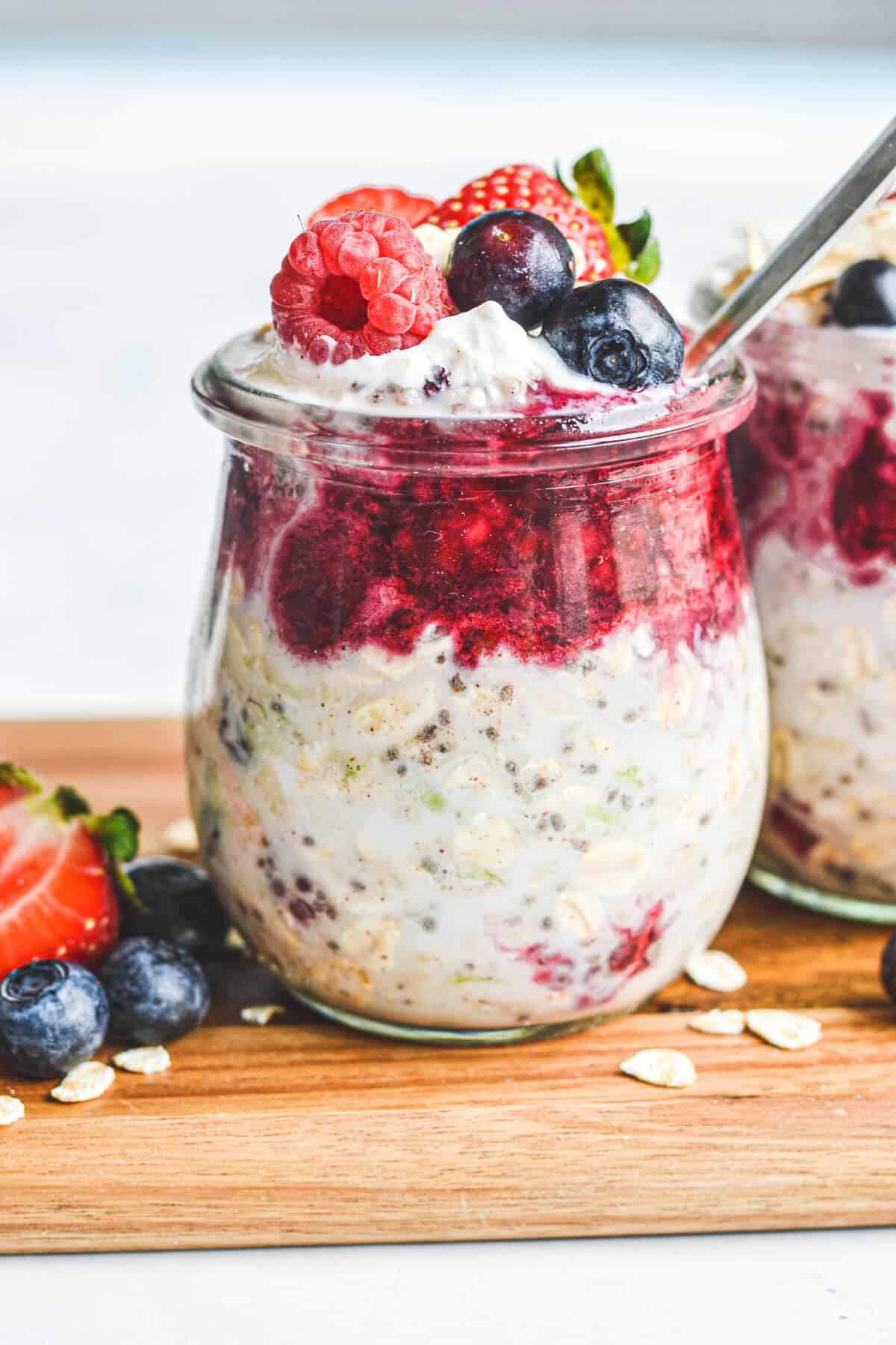 overnight oats in a glass jar covered with berries