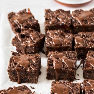 pieces of chocolate slice on a white board with melted chocolate