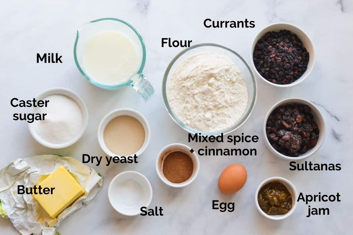 all ingredients for hot cross buns laid out on a table