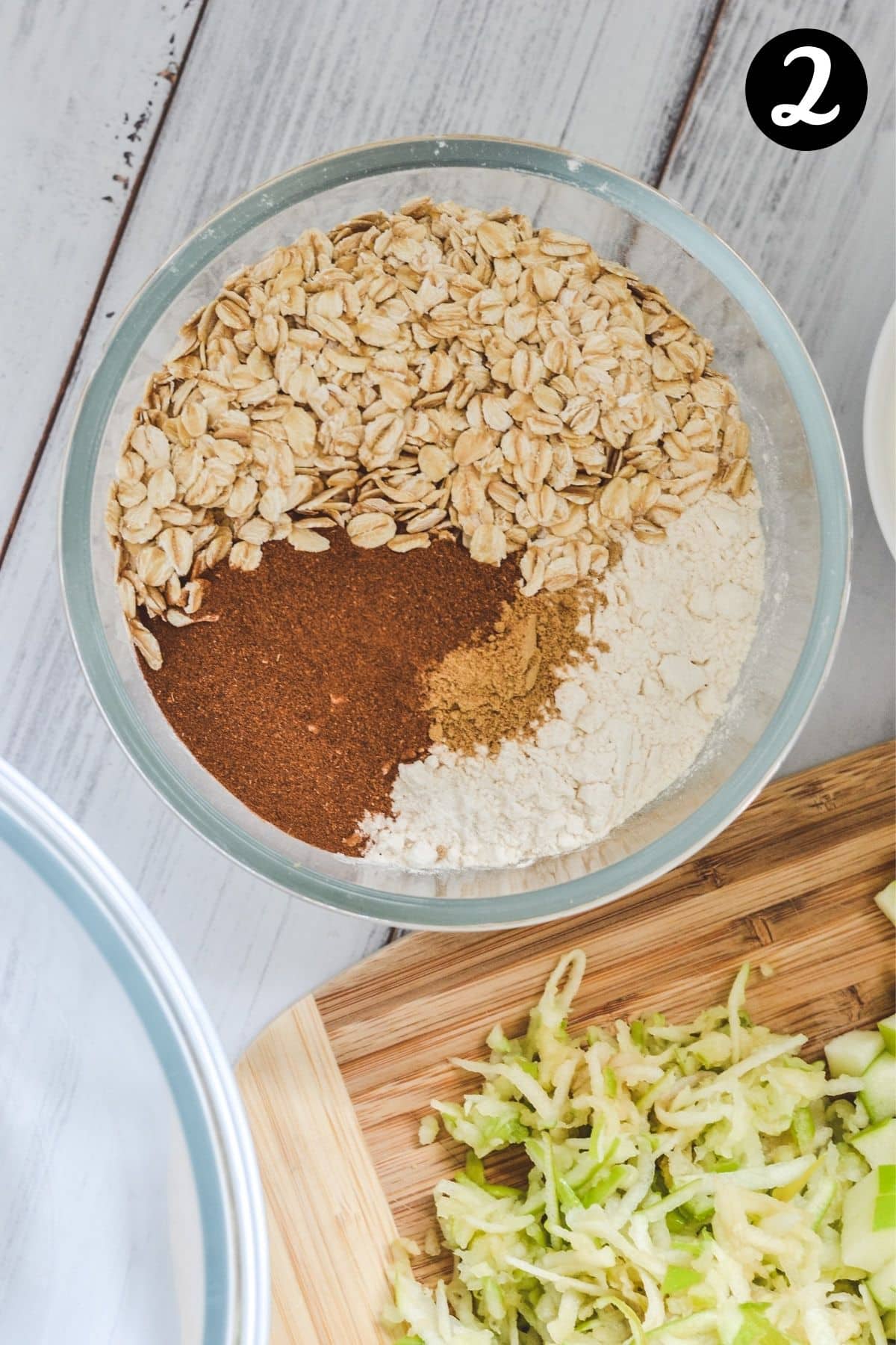 top view of flour, oats and spices in a glass bowl