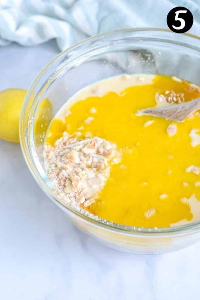 melted butter added to biscuit mixture in a glass bowl