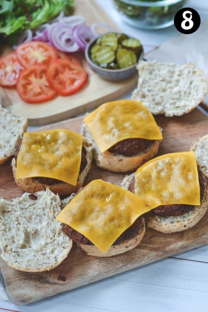 turkey burgers being assembled on a wooden board