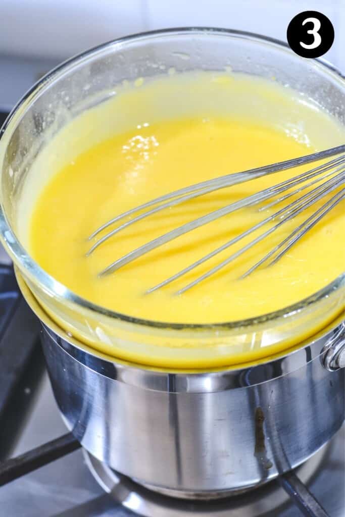 finished lemon curd in a bowl over heat