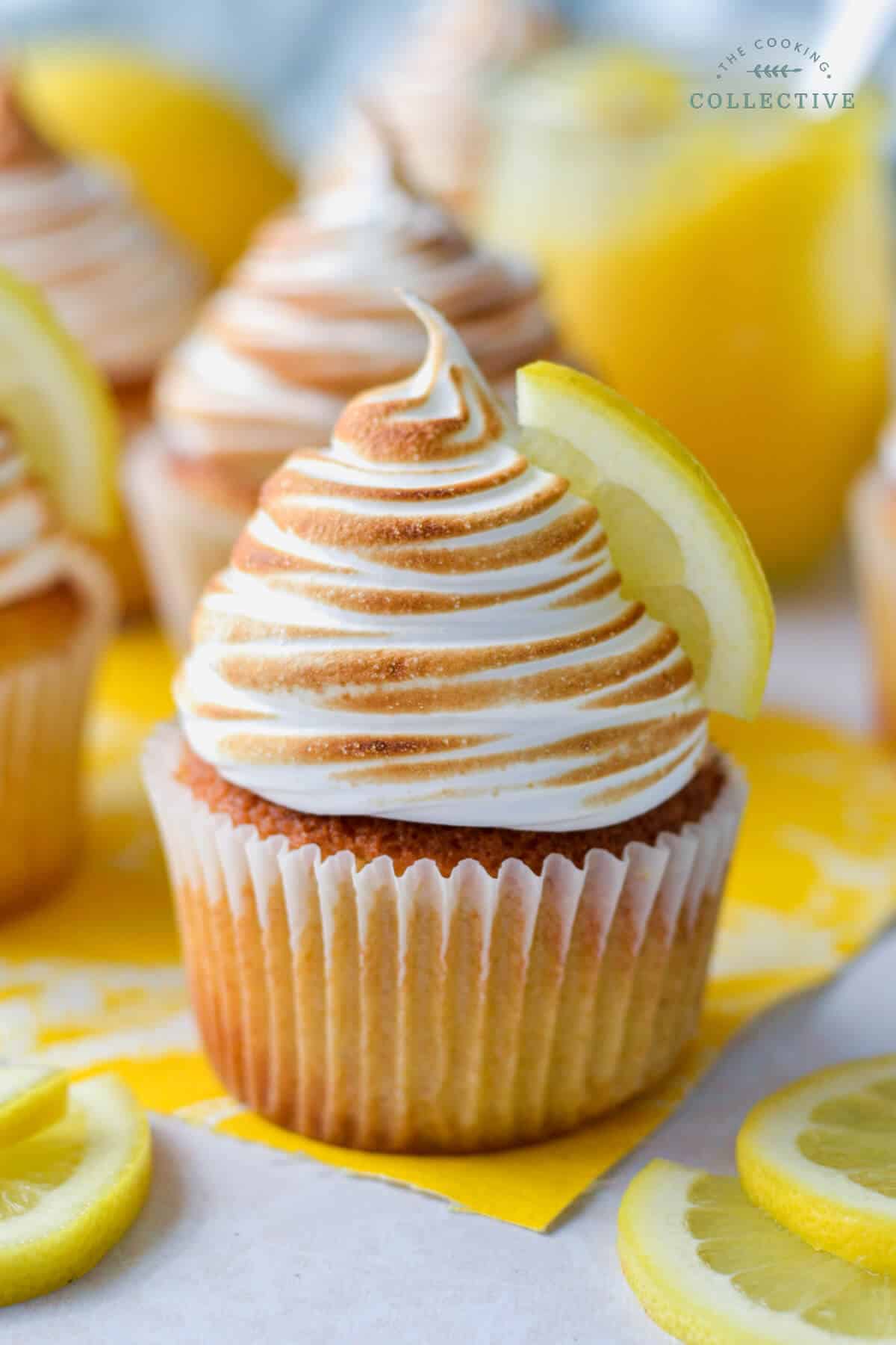 close up of a lemon cupcake topped with toasted meringue and lemon slices