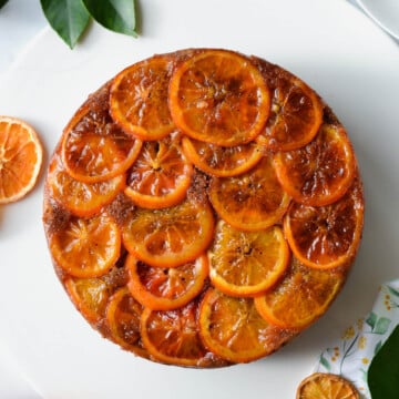 top view of an orange cake covered with orange slices and syrup