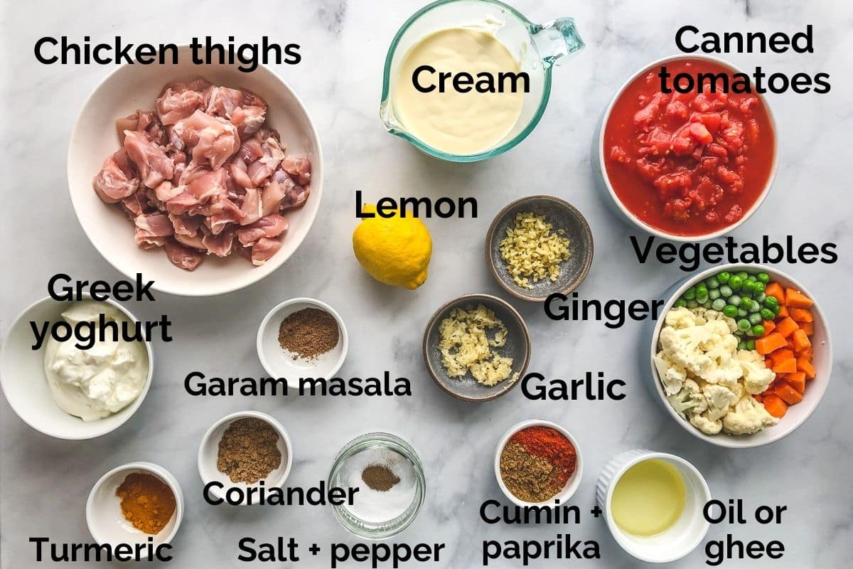 all ingredients for chicken tikka masala laid out on a table