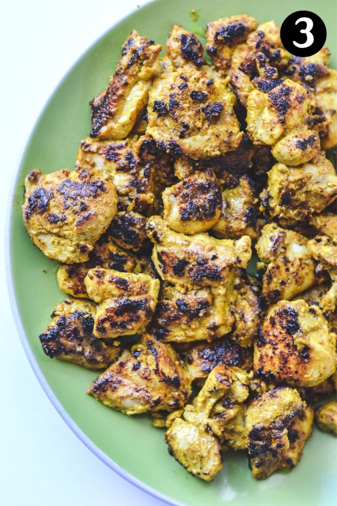charred chicken on a green plate