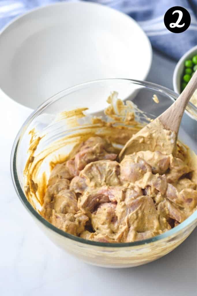 chicken coated in yoghurt and spices in a glass bowl