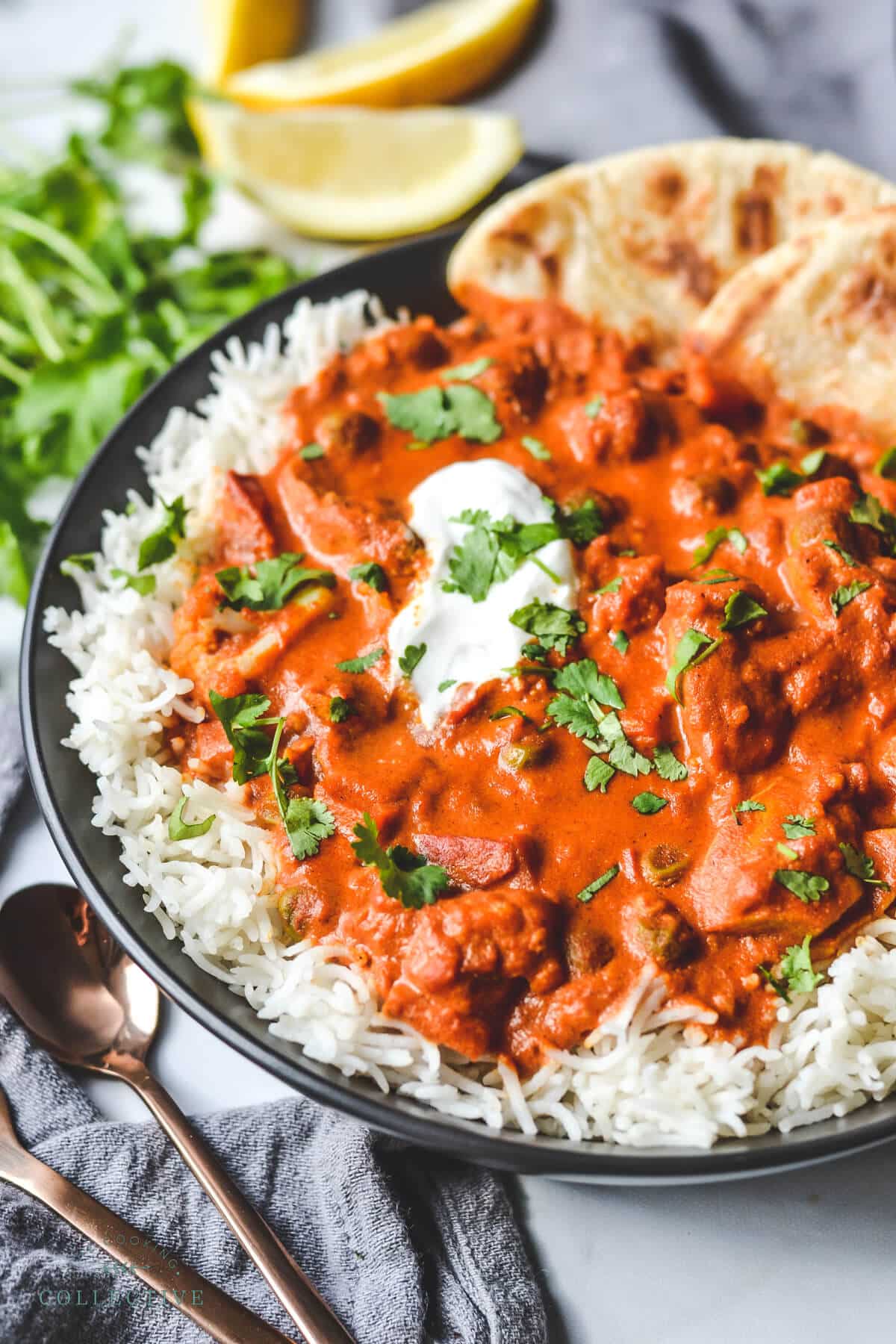 finished chicken tikka masala served over rice in a black bowl
