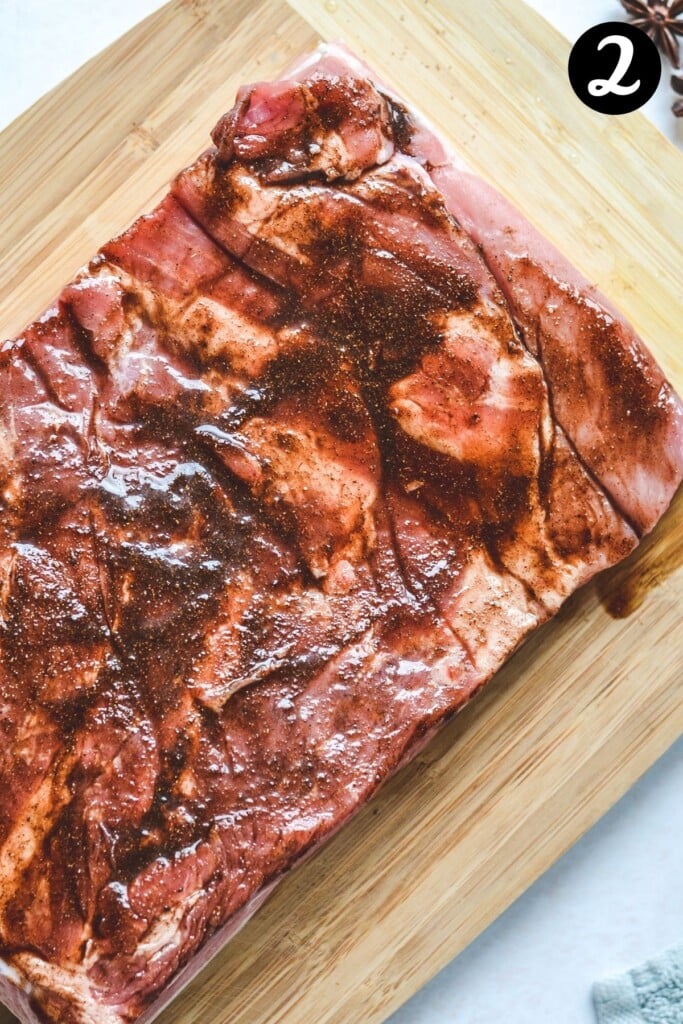 pork belly with spices on a wooden board