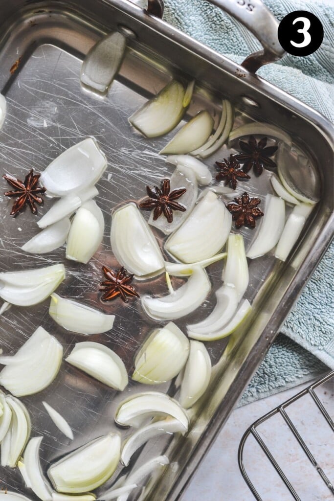 water, star anise and onion in an oven tray