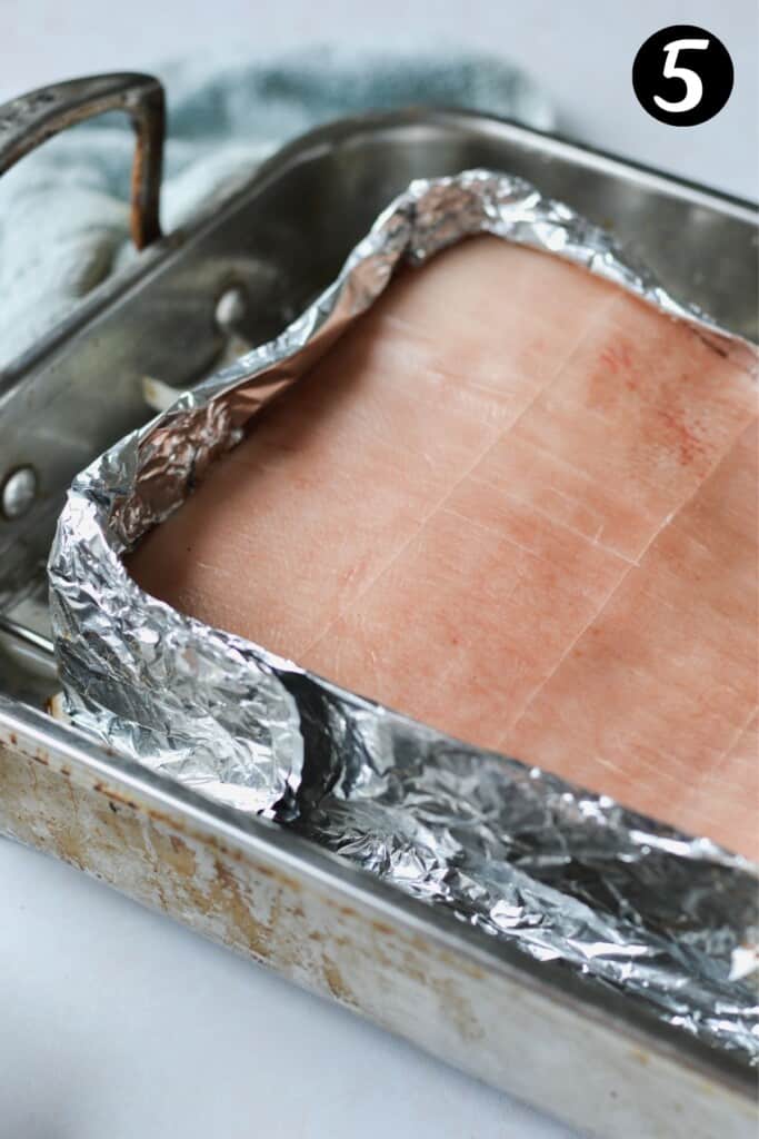 pork belly with foil covering the sides