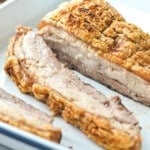 sliced pork belly in a white tray