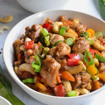 chicken and cashew stir fry in a white bowl